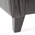 Fauteuil club contemporain capitonné en cuir reconstitué avec accoudoirs arrondis